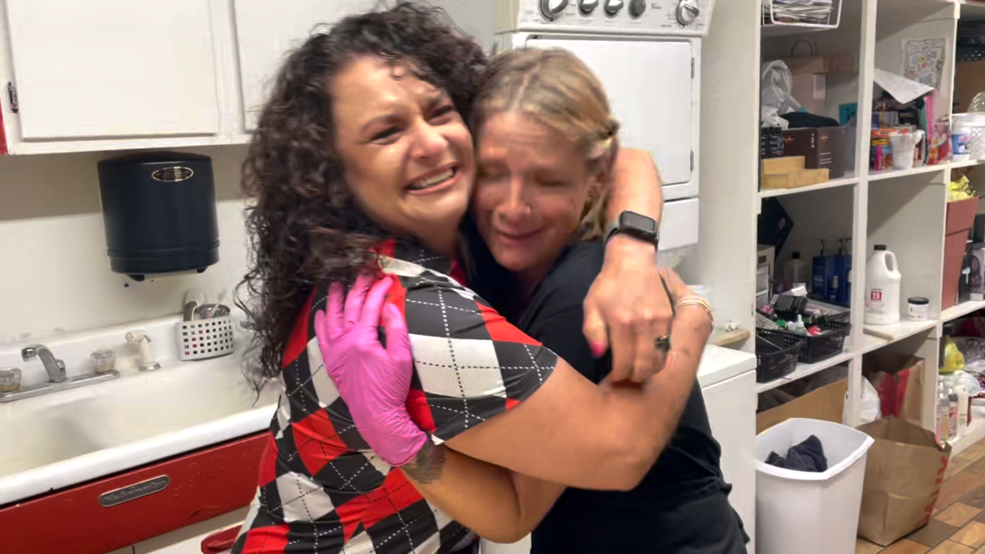 Margy Spillers hugs Christine Hohnke after receiving a $3,000 gift from OK PAYDAY